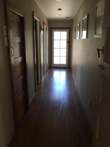 an empty hallway with a door and a window at Adventure B&B in Takaka
