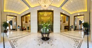 a lobby with a large building with a chandelier at S&N Zhejiang LinHai International Hotel in Linhai