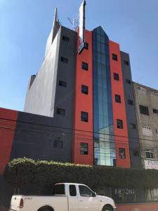 a white truck parked in front of a building at Hotel Ancona - S&oacute;lo Adultos in Mexico City