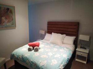 a bedroom with a bed with a stuffed animal on it at Marina View Apartment on the Maribyrnong River, Melbourne in Maribyrnong