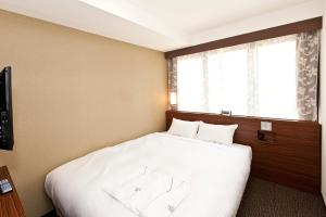 Postel nebo postele na pokoji v ubytování Sotetsu Fresa Inn Tokyo Tamachi