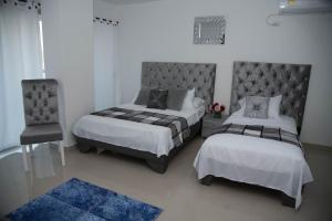 Giường trong phòng chung tại Hotel Platinum Barranquilla