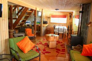 a living room with a table and a dining room at La Cabaña de Piedra in Las Trancas