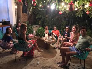 a large group of people sitting around a christmas tree at Paziflora Hostel in Puerto Escondido