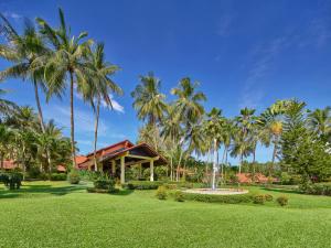 a resort with palm trees and a fountain at Dusit Thani Laguna Phuket in Bang Tao Beach