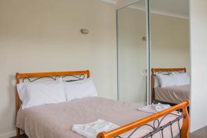 a bedroom with a bed and a dresser at Figtree Hotel Wollongong in Wollongong
