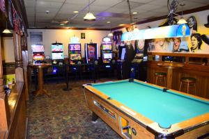 a pool table in a room with slot machines at Days Inn by Wyndham Rock Falls in Rock Falls