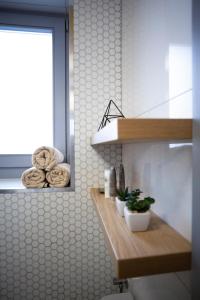 a bathroom with a counter with towels and a window at Yellow Apartment in Cluj-Napoca