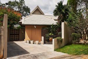 a house with a gate and a fence at Baan Manuchang Villa, SHA Certified in Ao Nang Beach