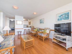 a living room with a couch and a table at Seaspray U4 21 Warne Tce in Caloundra