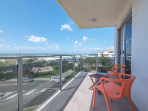 a balcony with a chair and a view of the ocean at Pacific Towers Unit 4, 19 Ormonde Tce Kings Beach in Caloundra