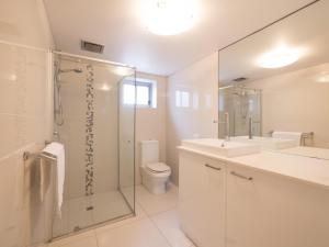 a bathroom with a shower and a sink and a toilet at Pacific Towers Unit 4, 19 Ormonde Tce Kings Beach in Caloundra