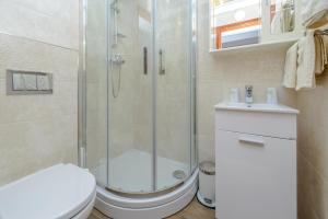a bathroom with a shower and a toilet and a sink at Studio Stradun in Dubrovnik