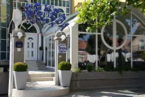 a store front of a building with blue signs on it at Hotel Ženeva in Kragujevac