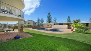 a yard with a swimming pool in a house at By The Sea Unit 4 13 Esplanade Kings Beach in Caloundra