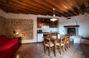 a kitchen and living room with a table and chairs at Hotel Al Castello in Bassano del Grappa