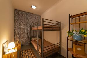 a room with two bunk beds and a window at Hostel PrzyMorze in Gdańsk