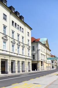 a row of buildings on a city street at City Centre Chic Apartment Ljubljana 2/4 in Ljubljana