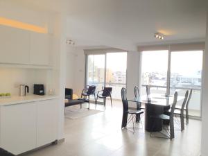 a kitchen and dining room with a table and chairs at RESIDENCE ONE in Limassol
