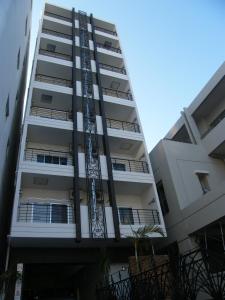 a tall apartment building with a fire escape at Sumuka Asato Station 1K[F-5] in Naha