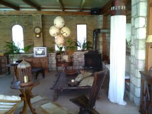 a living room with a couch and a fireplace at Nicolas Village Club in Néos Erineós