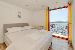ein Schlafzimmer mit einem Bett und einem großen Fenster in der Unterkunft Villa Boris in Trogir + 73 Fotos