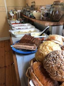 a bunch of bread and pastries on a table at Skäralids Camping & Vandrarhem in Ljungbyhed