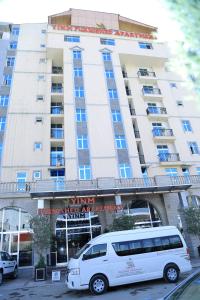 a white van parked in front of a building at Yinm Furnished Apartment in Addis Ababa