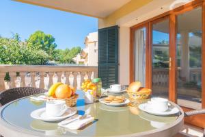 a table with food on top of a balcony at Can Besso in Alcanada