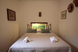 1 dormitorio con 1 cama con 2 toallas en Villa delle terrazze, en Punta Secca