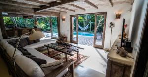 a living room with a couch and a table at Casa Angatu in Trancoso