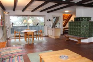 a living room with a table and chairs and a kitchen at Ferienhaus "Alte Mühle" in Wiehl