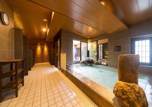 a large swimming pool in a building with at Dormy Inn Premium Tokyo Kodenmacho in Tokyo