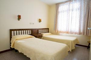 Posteľ alebo postele v izbe v ubytovaní Farilaga Apartments