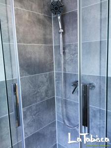 a shower with a glass door in a bathroom at Hotel Schurwald in Rechberghausen