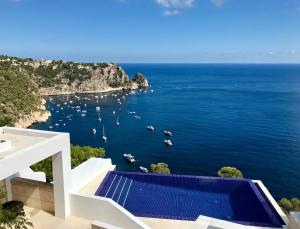 a view of the ocean from a house with a swimming pool at La Vie est Belle in Jávea