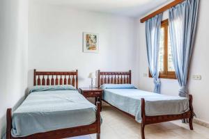 Posteľ alebo postele v izbe v ubytovaní Villa Punta des Port Quince