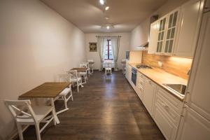 a kitchen with a table and chairs and a counter at Statek Jakubov in Vojkovice