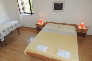 a bedroom with a large bed and two tables at Apartments Travarevic in Dubrovnik