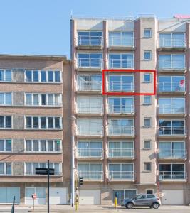 an apartment building with a red frame on it at Lumina Suite in Middelkerke