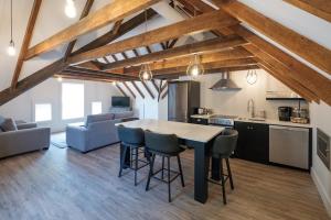 a kitchen and living room with a table and chairs at The Victorian Luxury Suites in Westport