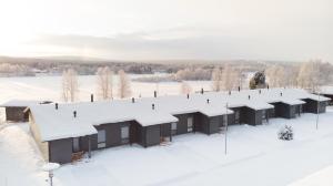a row of buildings in the snow at Riverside luxury suites in Rovaniemi