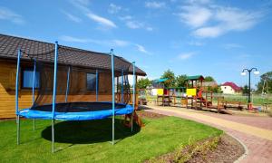 a playground with a trampoline in a park at Domki u Małgosi in Rusinowo