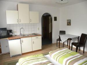 a kitchen with a couch and a table and a sink at Haus Renate in Lermoos