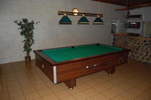 a pool table sitting in a room with ahibition at Inter-Bar-Motel in Nowe Marzy