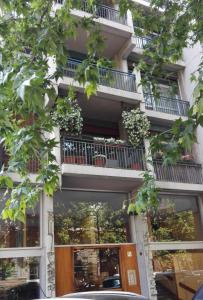 un condominio con balconi e porta in legno di In+out Sempione Park Apartment a Milano