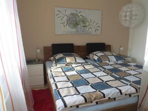 a bedroom with a bed with two pillows on it at Ferienwohnungen Familie Schwarze in Grenzach-Wyhlen