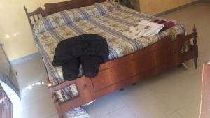 uma cama com uma moldura de madeira com um chapéu em CASA DI CARLO em Nápoles