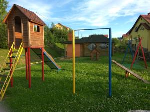a playground with a swing set and a house at Hotel Citadel in Skhidnitsa