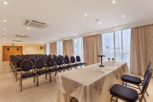 a conference room with a long table and chairs at Plaza Regency Hotels in Sliema